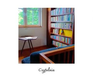 a room with two large bookshelves filled with books at Willa Witówka in Olszówka