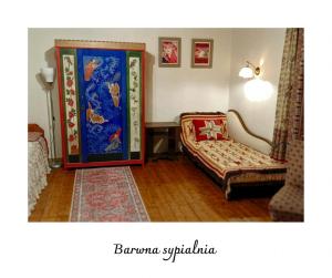 a living room with a chair and a door at Willa Witówka in Olszówka