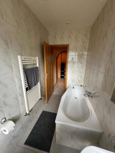 a bathroom with a bath tub and a sink at Ruhige Wohnung in Gelsenkirchen in Gelsenkirchen