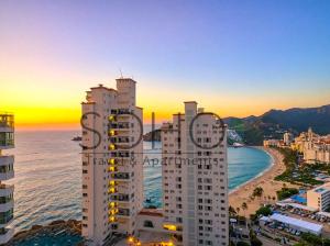 an aerial view of a city and a beach with buildings at Peñón del Rodadero Apartments – Oceanfront by SOHO in Rodadero