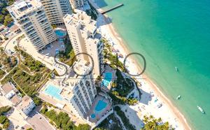 an aerial view of a beach with buildings and the ocean at Peñón del Rodadero Apartments – Oceanfront by SOHO in Rodadero +52 photos