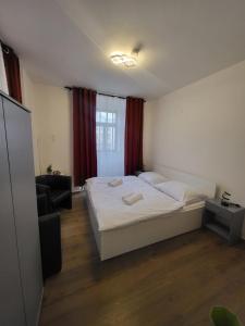 a bedroom with a bed and a chair and a window at Nefrit Garni & Bar in Česká Kamenice