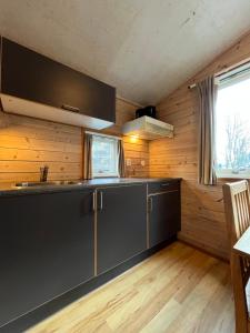 a kitchen with a sink and a counter top at Trolltunga Camping in Odda
