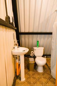 a small bathroom with a toilet and a sink at Casa Monte Bello- Cabaña privada in Huehuetenango +91 photos