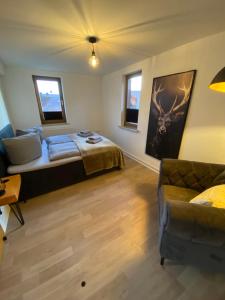 a bedroom with a bed and a couch at Forrest Lounge Schweina in Bad Liebenstein