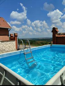 a swimming pool with a view of a house at House 33 in Stari Slankamen