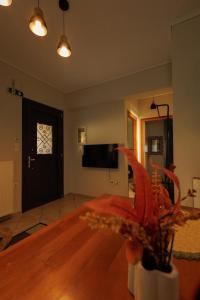 a living room with a door with a clock on it at Η Μουριά in Konitsa