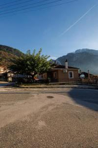 an empty street in front of a house at Η Μουριά in Konitsa
