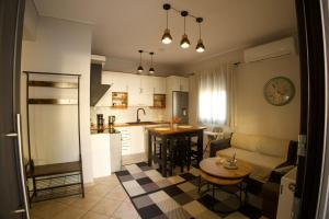 a kitchen and living room with a couch and a table at Η Μουριά in Konitsa