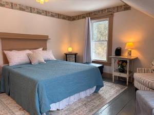 a bedroom with a blue bed and a window at My Valhalla Farm in Oakland +28 photos