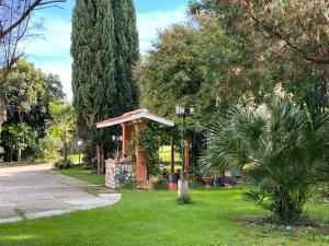 a gazebo in a park with trees and grass at Nel giardino segreto in San Giorgio a Liri