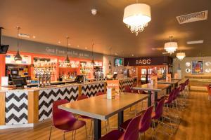 a restaurant with tables and chairs and a bar at My Spacious Kentish 3-Room Van in Birchington