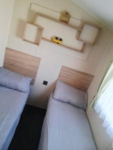 a bedroom with two beds and a yellow car on the ceiling at My Spacious Kentish 3-Room Van in Birchington +9 photos