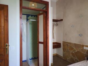 a bathroom with a shower and a glass door at Casa MaCló Tranquilidad y autenticidad in Máguez +15 photos