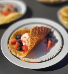 a waffle with fruit and ice cream on a plate at Rozulas skola in Rozula +31 photos