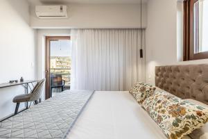a hotel room with a bed and a balcony at Anna Studio in Amoudara Herakliou