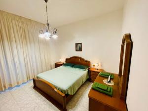 a bedroom with a bed and a dresser and a table at House of Arcadia in Pistoia +25 photos