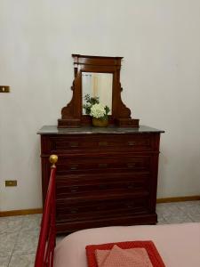 a dresser with a mirror on top of it at House of Arcadia in Pistoia
