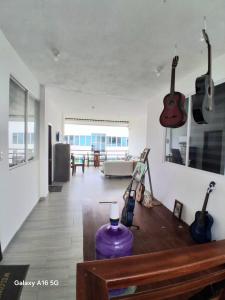 a living room with guitars hanging on the wall at Barrio Central in Puerto Ayora
