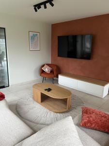 a living room with a couch and a coffee table at Noordzeehuys in Middelkerke