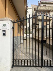 a black metal gate in front of a building at  