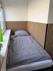 a bed in a room with a wooden headboard at Tuvalu in Remagen