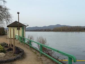 a small green building next to a body of water at Tuvalu in Remagen +3 photos