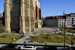 a church with a car parked in front of it at Apartament Piast w Rynku in Nysa