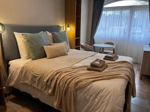 a bedroom with a large bed with towels on it at Boutique hotel Zeelui in Egmond aan Zee