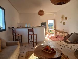 a living room with a couch and a table at Chambres Maison d'hôtes MaisonBlanche in Essaouira