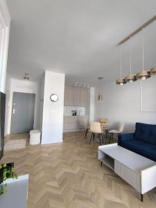 a living room with a blue couch and a table at Apartamenty Sady in Słubice