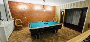 a pool table in a room with a brick wall at Apartman Tatranská Štrba in Štrba