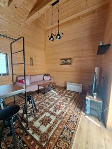 a living room with a couch and a table at Straza in Rožanstvo