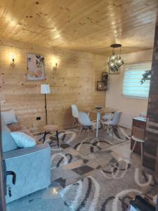 a living room with a couch and a table at Straza in Rožanstvo