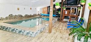 a large swimming pool in a room with at Apartman Tatranská Štrba in Štrba