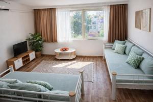 a living room with a couch and a table at Kavala Hotel Bodrum in Bodrum City