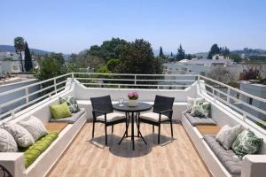 a patio with a table and chairs on a balcony at Kavala Hotel Bodrum in Bodrum City