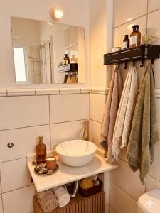 a bathroom with a sink and a mirror and towels at Apartamento Gades Conil C in Conil de la Frontera