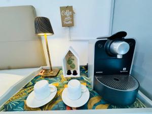 a coffee maker and cups on a table in a room at Mini Estudio Málaga in Málaga