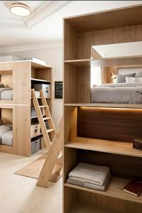 a room with two bunk beds and a bedroom at Your Home In Riyadh Hostel in Riyadh