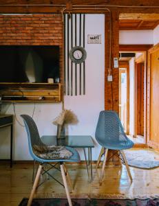 a room with two chairs and a table and a flag at National Monument Konak in Stolac