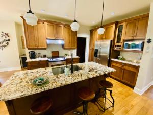 a kitchen with wooden cabinets and a granite counter top at Qualicum Landing Paradise in Qualicum Beach