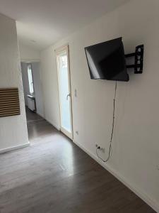 a flat screen tv on a wall in a room at Arcadia in Remagen