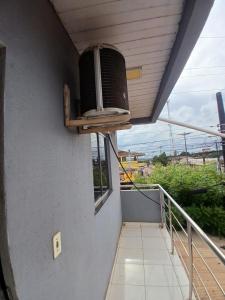 a balcony with a tv on a wall at Pousada JC 50 in Santarém
