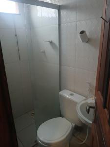 a bathroom with a toilet and a shower and a sink at Pousada JC 50 in Santarém