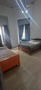a room with two beds and a window at Hostel Las Lengas in Buenos Aires