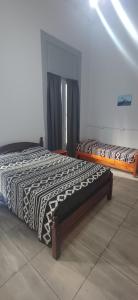 a bedroom with two beds in a room at Hostel Las Lengas in Buenos Aires