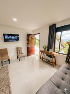 a living room with a couch and a table at Pilarica Gardens in Medellín