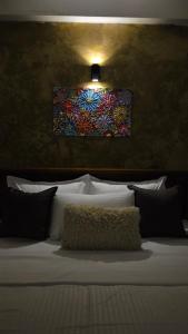 a bedroom with a bed with a painting on the wall at Casa Jose - 2BR with King Beds, Near Airport and Beach, 5G Wi-Fi in Wattala