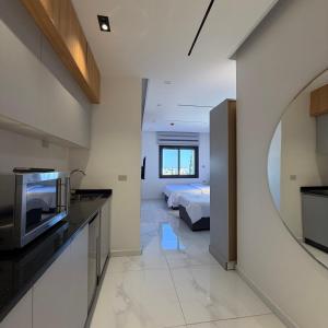 a kitchen and living room with a bed in the background at ريڨا للأجنحة السكنية Riva suites in Irbid